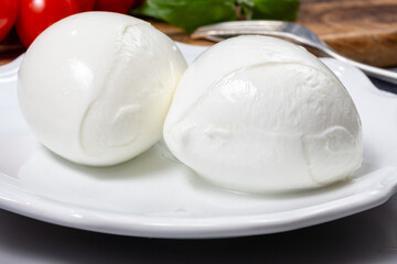 Tasty italian food, fresh white buffalo mozzarella soft cheese balls from Campania close up