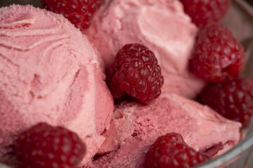 delicious sweet cold raspberry-flavored ice cream and ripe raspberries in a glass