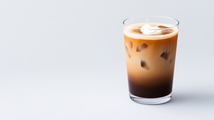 A refreshing glass of iced coffee with cream on top.