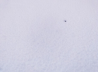 Little hole on the ground covered with snow backdrop