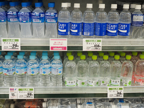 CHIBA, JAPAN - December 30, 2024: Bottles of mineral water and sports drinks in a refrigerator in a supermarket.