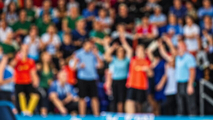 Blurred background of supporters at sports event crowd of people in a basketball court