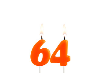 Lit birthday candle - Candle number 64 on white background.