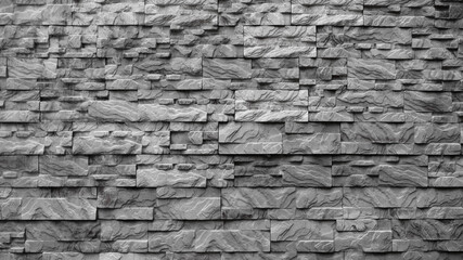 The photo shows decorative facing tiles in the form of grey bricks