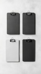 Four Blank Black and White Clipboards on a Concrete Background - Minimalist Office Supplies