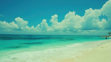 Obraz premium Serene Tropical Beach with Clear Blue Water and Fluffy Clouds