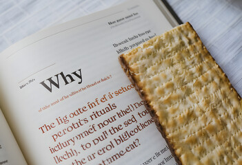 open haggadah book with matzah bread, symbolizing the passover story and traditions