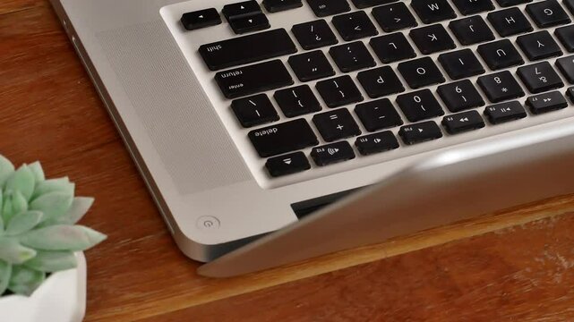 Motion close up finger click delete button. Concept of digital and delete from storage. The index finger presses the delete key on the laptop keyboard.