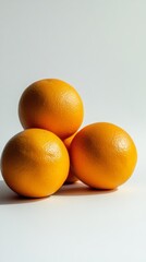 Three Vibrant Oranges: A Close-Up Still Life of Fresh Citrus Fruit