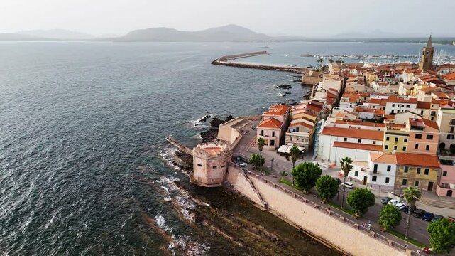 Scenic drone view of Alghero's coastline and historic town during a bright summer day