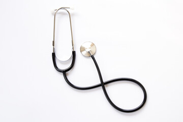 Stethoscope on white background, top view