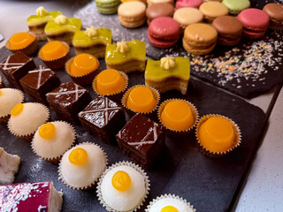Dessert Buffet with assorted small cakes, pastries and sweets in buffet service restaurant close up