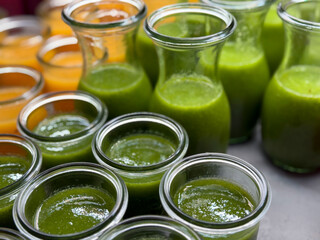 Fresh smoothie drinks made of fresh fruits, berries and vegetables in glass jars in buffet restaurant