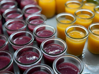 Fresh smoothie drinks made of fresh fruits, berries and vegetables in glass jars in buffet...