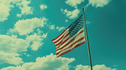 "USA Flag Flying High Against a Clear Blue Sky and White Clouds"