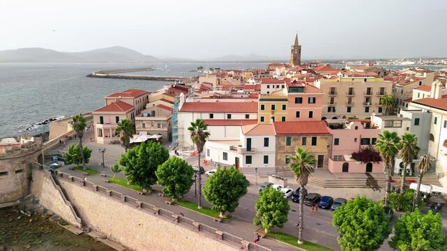 Scenic drone view of Alghero's coastline and historic town during a bright summer day