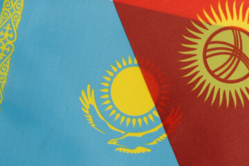 Kazakhstan and national flag Kyrgyzstan together on textile background.