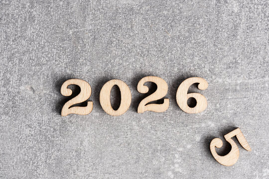 New Year 2026 with wooden numbers on grey background. Copy space.