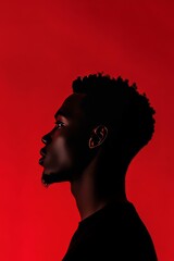 Minimalist portrait of an African man's silhouette against a vibrant red background