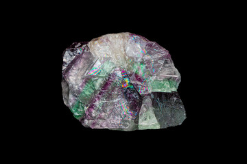 Natural rough rainbow fluorite gemstone on dark background (selective focus)