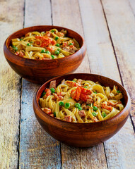 crawfish alfredo pasta served in wooden bowls