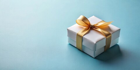 Fototapeta premium A single, white, square gift box with a gold ribbon bow on a light blue background.