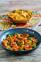 taco style shrimp served with a coconut chili sauce served in a skillet