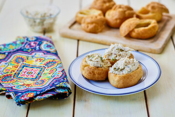 chicken salad puffs on a blue napkin