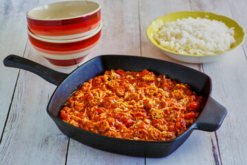 crab gumbo presented in a cast iron skillet