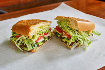 fried avocado sandwich with tomato and shredded lettuce