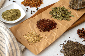 A flat-lay of herbal seeds on brown parchment paper