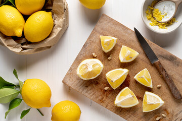 Group of lemons on light wooden table.