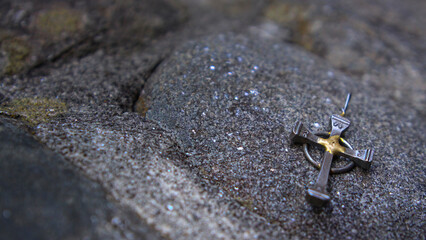 Small Horseshoe Nail Cross on Stone Side
