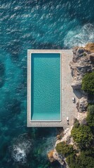 Beautiful cliffside swimming pool overlooking the ocean with clear blue water in a serene location