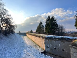 Mountain view between the ancient walls when it is snowing 