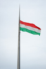 Flying Hungarian flag in front of the parlament building in capital Budapest, Hungary