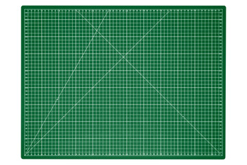 A big green cutting mat with a white grid is isolated.