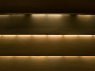 Three strips with top warm cornice lighting, background.