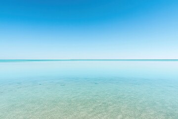 Fototapeta premium Tranquil clear waters reflect the blue sky over a serene coastal landscape