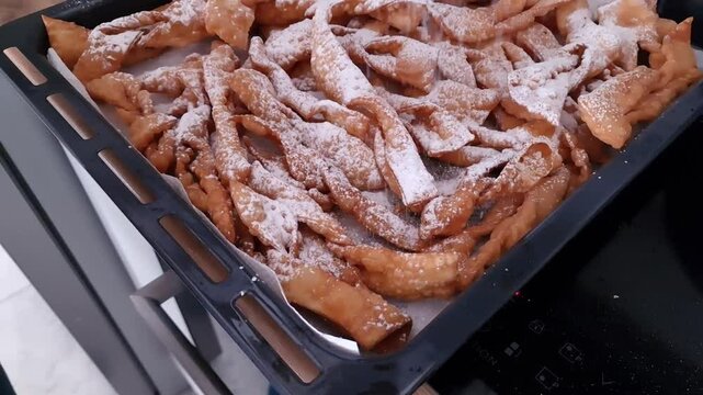 Freshly made angel wings cookies with powdered sugar