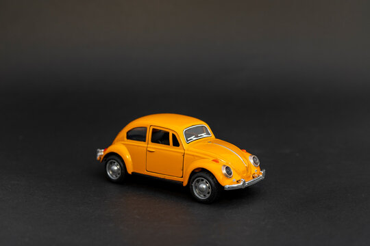 Front view of a Yellow toy car on a black background