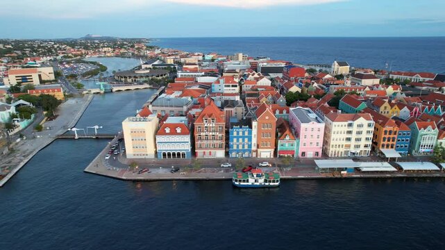 Drone footage of the colorful waterfront houses of Handelskade with Queen Emma Bridge