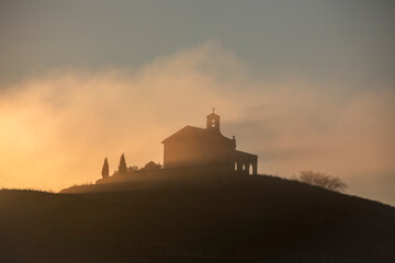 Obraz premium View of the hermitage of Santa Quiteria on a hill in an idyllic sunrise with golden light in Cuenca, Spain