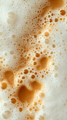 A Delicate Dance of Creamy Coffee Foam: A Close-up View of a Refreshing Beverage
