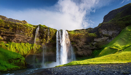 Obraz premium waterfall in the mountain valley icelandic nature photo landscape outdoor travel