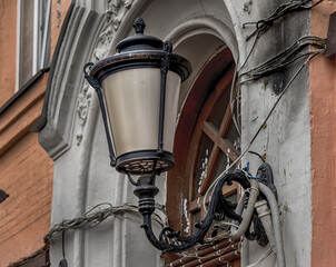 A street lamp that illuminates a part of the old town.