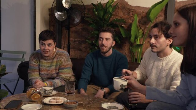 Group of friends chatting and enjoying tea in a cozy setting - Strengthening friendships through meaningful conversations