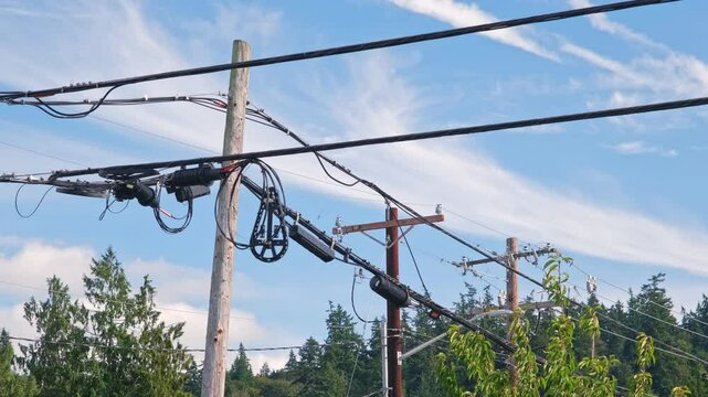 Urban Infrastructure Wooden Utility Poles with Overhead Power Lines and Fiber Optic Cable for Broadband Internet Service Provider