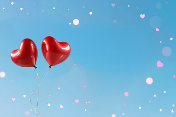 Two balloons floating against clear blue sky. With copy space.
