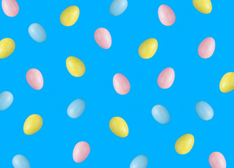 Colored easter eggs on the blue background. Top view. Flat lay. Pattern.